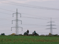 two bicycles are seen in front of two Electricity transmission pylons in Wesseling, Germany on Oct 17, 2021 (