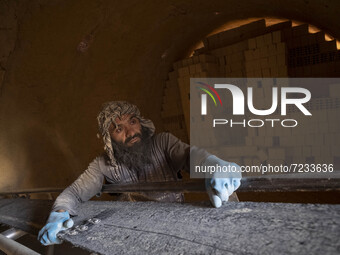 An Afghan refugee labor works in a brick factory, in the Borkhar area in the west of the city of Isfahan 439Km (273 Miles) southern Tehran o...