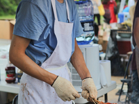 Chinese chef barbeques squid on a stick during the Festival of Asia in Markham, Ontario, Canada, on June 25, 2011. (