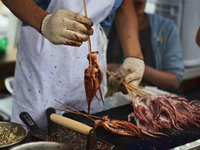 Chinese chef barbeques squid on a stick during the Festival of Asia in Markham, Ontario, Canada, on June 25, 2011. (