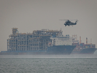 Royal New Zealand Air Force SH-2G(I) Seasprite maritime helicopter flies past maritime vessels at Marina South on October 18, 2021 in Singap...