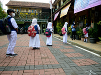 Students stand in a queue as they wait for their turn for washing hand at a primary school in Bogor, West Java, Indonesia, on October 18, 20...