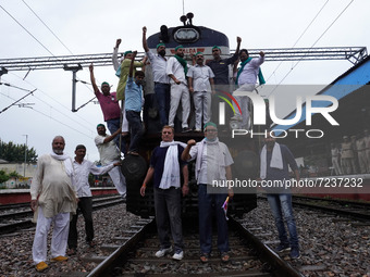 Farmers shout slogans as they block railway tracks during a nationwide rail blockade demanding dismissal of Union Minister Ajay Mishra, days...