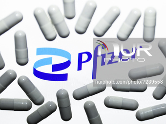 Pfizer logo displayed on a laptop screen and medical pills are seen in this illustration photo taken in Krakow, Poland on October 18, 2021....