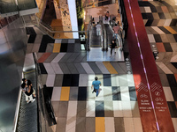 People wearing protective face masks walk in a shopping mall in Singapore, on Tuesday, 19 October 2021. The U.S. Centers for Disease Control...