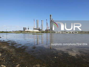 SpaceX's South Texas Launch Site reflects in the shallow marshes of Boca Chica, Texas on October 18th, 2021.  (