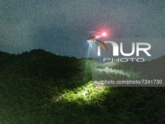 An airbus helicopter of the Government Flying Services illuminates Kowloon Peak with projectors to find lost hiker, in Hong Kong, China, on...