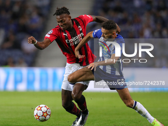 Porto’s Portuguese midfielder Bruno Costa (R) vies with Rafael Leao forward of AC Milan (L) during the UEFA Champions League Group stage - G...