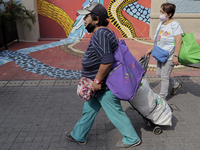 Two women walk on Regina Street in the Historic Centre of Mexico City, during the COVID-19 emergency and the official return to the green ep...