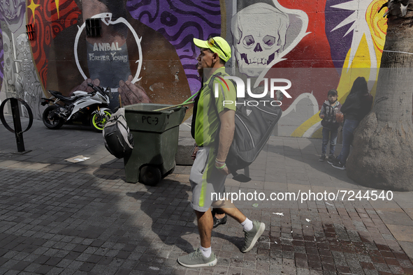 A passer-by on Regina Street in Mexico City's Historic Centre during the COVID-19 emergency and the official return to the green epidemiolog...