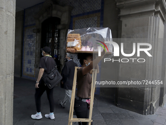 A meringue vendor in the streets of the Historic Centre of Mexico City, during the COVID-19 emergency and the official return to the green e...