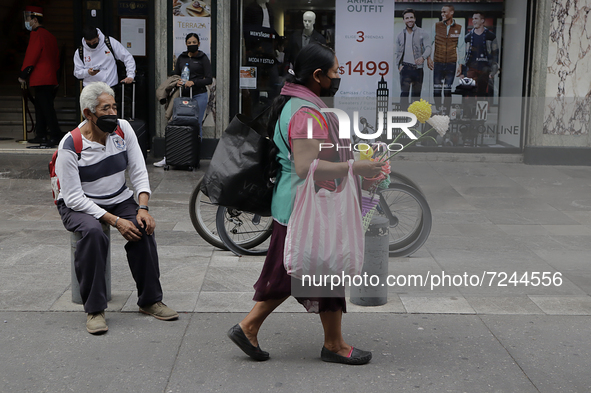 A woman walks in the streets of the Historic Centre of Mexico City during the COVID-19 emergency and the official return to the green epidem...