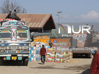 Labourers load trucks with Apple Boxes at Fruit mandi in Sopore, District Baramulla, Jammu and Kashmir, India on 20 October 2021. Traders at...
