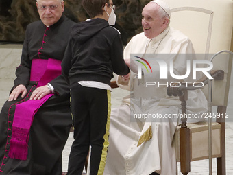 Pope Francis talks with a 10-year-old boy Paolo Junior, family name not available, after he unexpectedly walked up to him at the beginning o...