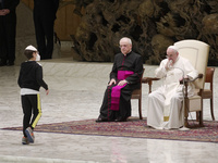 Pope Francis talks with a 10-year-old boy Paolo Junior, family name not available, after he unexpectedly walked up to him at the beginning o...