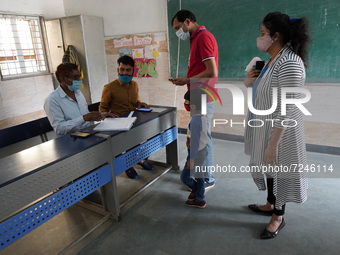 People register themselves to get inoculated against coronavirus inside a school in New Delhi, India on October 20, 2021. India is inching c...