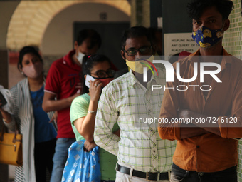 People line up to get inoculated against the coronavirus inside a school in New Delhi, India on October 20, 2021. India is inching closer to...