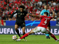 Leroy Sane of Bayern Muenchen (L) vies with Lucas Verissimo of SL Benfica during the UEFA Champions League group E football match between SL...
