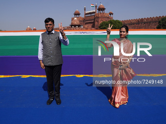 Indian Health Minister, Mansukh Mandaviya (L) along with Minister of State (MoS) Health, Bharati Pawar, gesture during an event as India cel...
