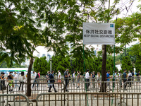 Social distancing flags are hung above the entrance lines for competitors of the Hong Kong marathon to line up to pick their race kit and un...