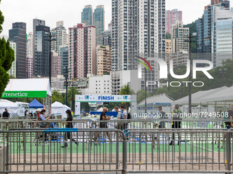 People pass before the finish line in Victoria Park. Competitors of the Hong Kong marathon came to pick their race kit and undergo Covid-19...