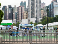 People pass before the finish line in Victoria Park. Competitors of the Hong Kong marathon came to pick their race kit and undergo Covid-19...