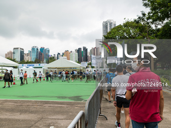 Runners prepare for registration in Victoria Park to compete in the Hong Kong marathon.. Competitors of the Hong Kong marathon came to pick...