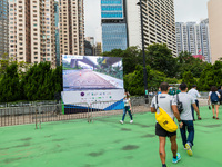 A screen shows the race path as competitors of the Hong Kong marathon came to pick their race kit and undergo Covid-19 tests. The race is on...