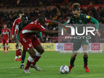  Uche Ikpeazu of Middlesbrough in action with Barnsley's Jordan Williams during the Sky Bet Championship match between Middlesbrough and Bar...