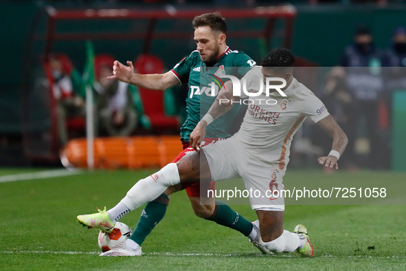 Maciej Rybus (L) of Lokomotiv Moscow and Patrick van Aanholt of Galatasaray vie for the ball during the UEFA Europa League Group E football...
