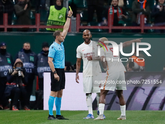 Ryan Babel (R) of Galatasaray argues as the referee Harald Lechner (L) shows him yellow card during the UEFA Europa League Group E football...