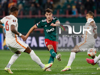 Konstantin Maradishvili (C) of Lokomotiv Moscow shoots on goal as Patrick van Aanholt (L) and DeAndre Yedlin of Galatasaray defend during th...