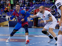 Domen Makuc of FC Barcelona in action with Henrik Toft Hansen of PSG Handball during the EHF Champions League match between FC Barcelona and...
