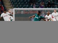Gyrano Kerk (C) of Lokomotiv Moscow vies for the ball with Patrick van Aanholt (L) and Marcao of Galatasaray during the UEFA Europa League G...