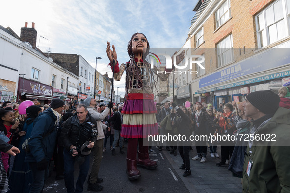 LONDON, UNITED KINGDOM - OCTOBER 22, 2021: Little Amal, a 3.5 metre-tall giant puppet representing a nine-year-old Syrian refugee child, is...