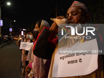 A man blows conch shell during a protest on recent atrocities against minority Hindu in Bangladesh at Kathmandu, Nepal on Friday, October 22...