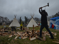 A general view of a 'sit-in' camp that consists of five teepees, a dozen tents and a sacred fire, set in the Alberta Legislative Grounds. 
A...