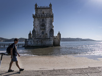 A person walks near the Torre de Belem tourist area in Lisbon. 20 October 2021. Most regions in mainland Portugal show an 