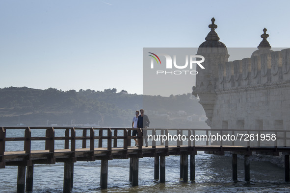 People walk near the Torre de Belem tourist area in Lisbon. 20 October 2021. Most regions in mainland Portugal show an 