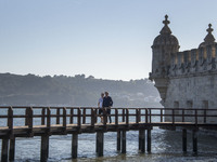 People walk near the Torre de Belem tourist area in Lisbon. 20 October 2021. Most regions in mainland Portugal show an 