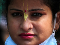 A demonstrator chants religious prayers as she participates in a protest against the recent religious violence against the Hindu community i...