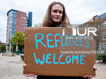 A Dutch woman is holding a placard in support of refugees, during a demonstration organized by the group 'We Are Here' to demand permanent r...