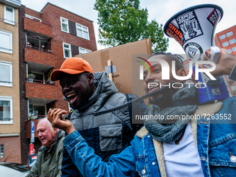 An undocumented Black man is shouting slogans in support of refugees, during a demonstration organized by the group 'We Are Here' to demand...