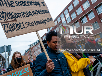 An undocumented man is holding a placard asking for a solution, during a demonstration organized by the group 'We Are Here' to demand perman...