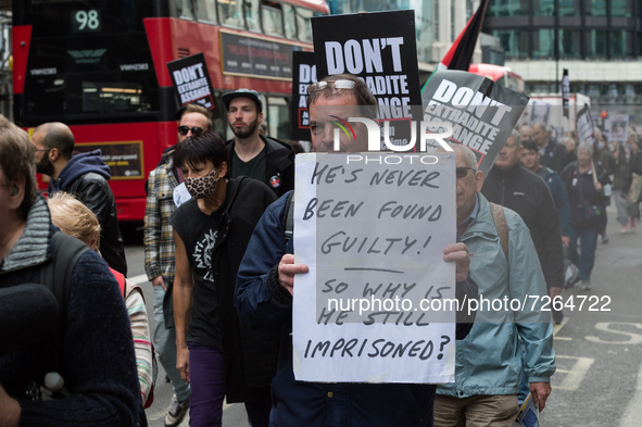 LONDON, UNITED KINGDOM - OCTOBER 23, 2021: Demonstrators march through central London in solidarity with Julian Assange ahead of next week's...