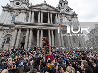 LONDON, UNITED KINGDOM - OCTOBER 23, 2021: Little Amal, a 3.5 metre-tall giant puppet representing a nine-year-old Syrian refugee child, is...