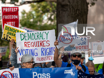 Protesters cheer and lift signs during a rally at the end of a relay for voting rights at the US Capitol.  Protesters began the relay in Wes...