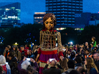 'Little Amal', a giant puppet depicting a Syrian refugee girl, walks through Waterloo Bridge in London, Britain, 23 October 2021. A giant do...