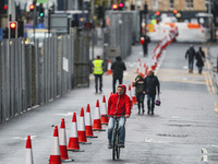 A pedestrian cycles near the Scottish Event Campus on September 1, 2021 in Glasgow, Scotland. The Scottish Event Campus IS one of the host v...