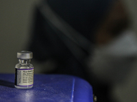 The bottle to be injected into a person with a dose of the Pfizer-BioNTech Comirnaty COVID-19 vaccine against the coronavirus disease (COVID...